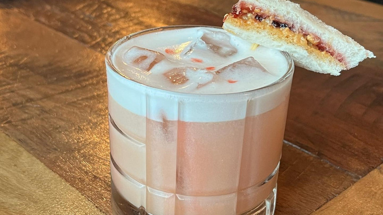 Foamy cocktail with skewered PB&J sandwich