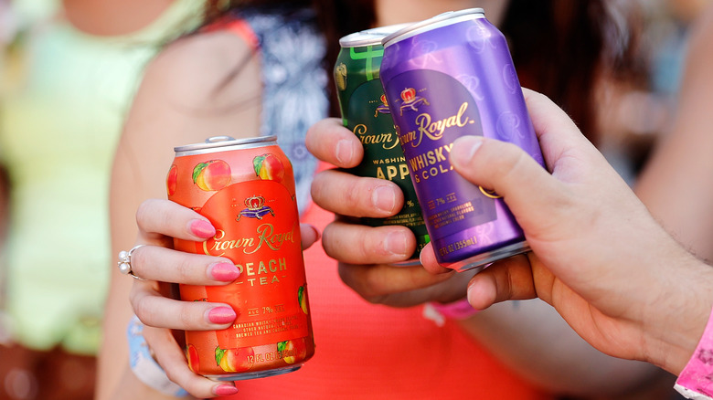 people drinking canned cocktails