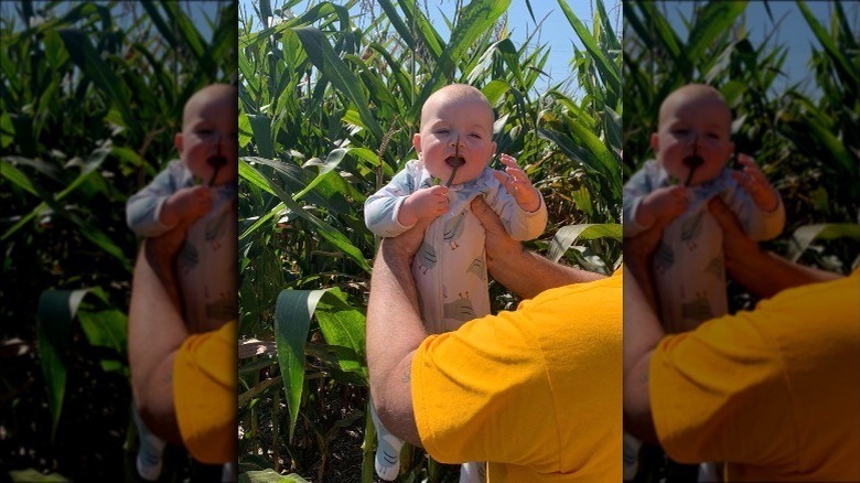 Duff Goldman holding his daughter in corn field