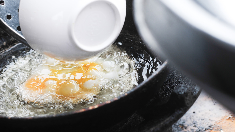 Pouring water onto fried eggs