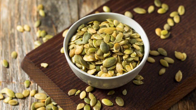 Green pepitas on wood countertop