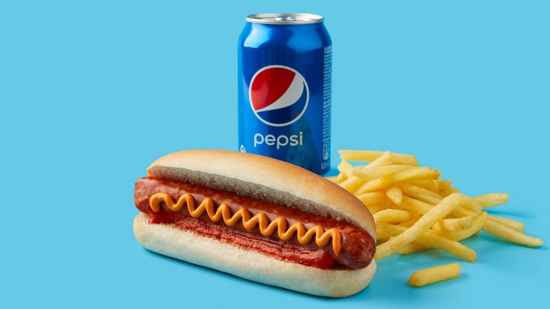 Pepsi and hotdog with ketchup and mustard