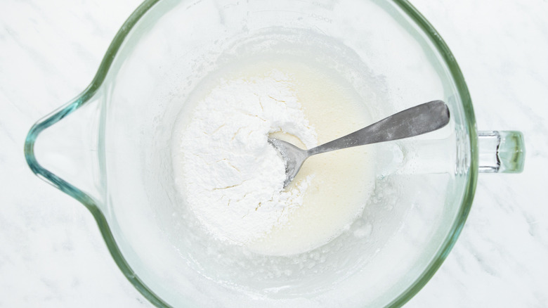 egg whites and powdered sugar in bowl 