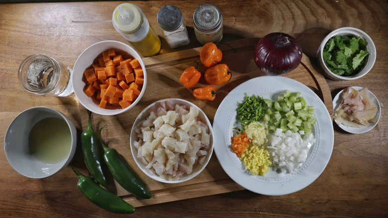 Peruvian-style ceviche ingredients laid out on wooden table