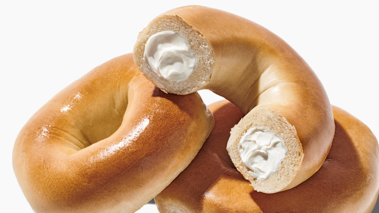 Whole plain bagels with a cream cheese filling.