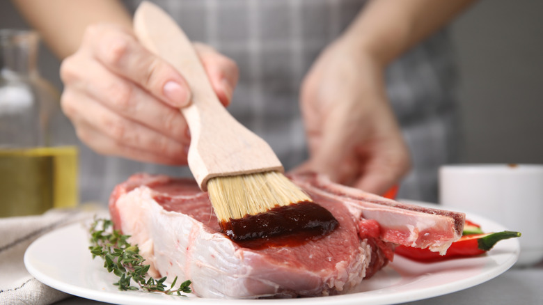 brushing on marinade on meat