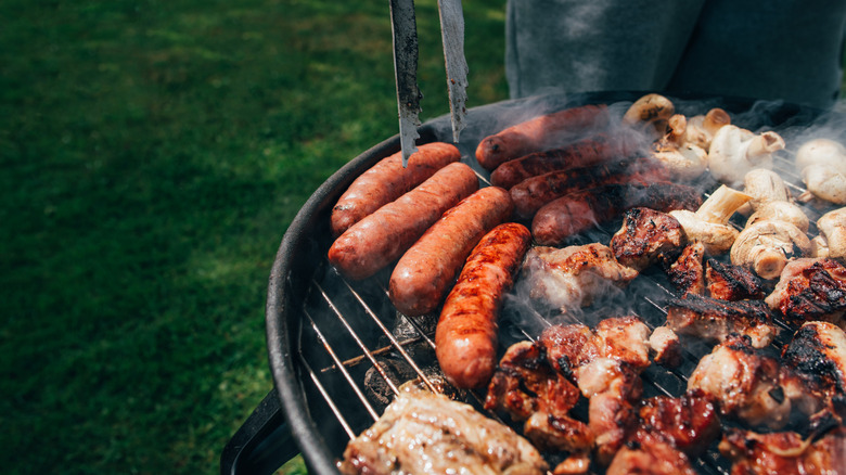 meat on grill with tongs