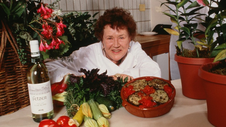 Julia Child posing with food and drink