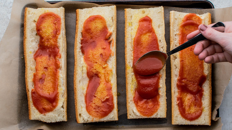 applying sauce to bread slices