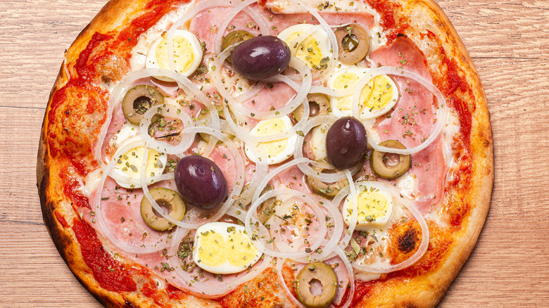 pizza with eggs olives and onions