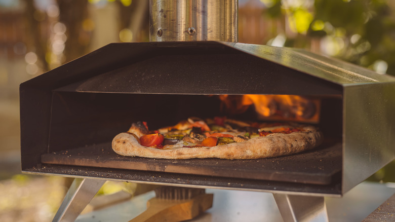 Pizza baking in an outdoor oven