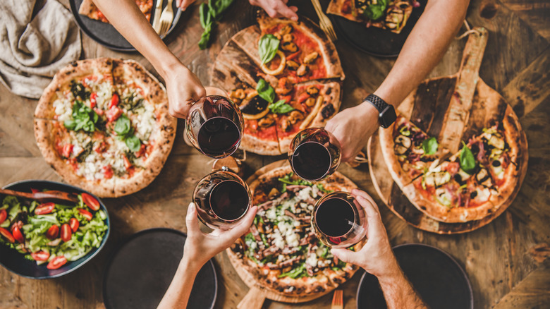 group of people eating pizza