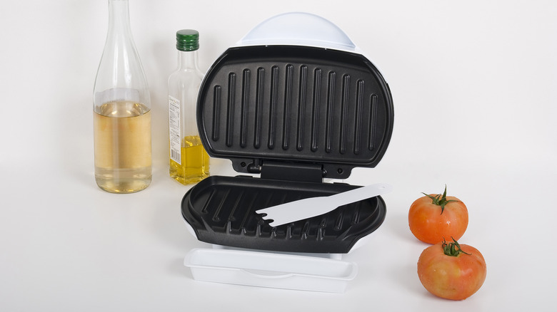 open panini press with ingredients