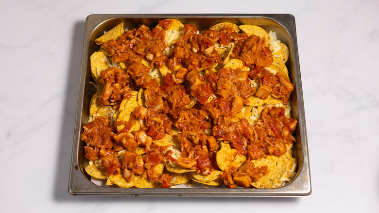 jackfruit on top of corn chips in baking tray