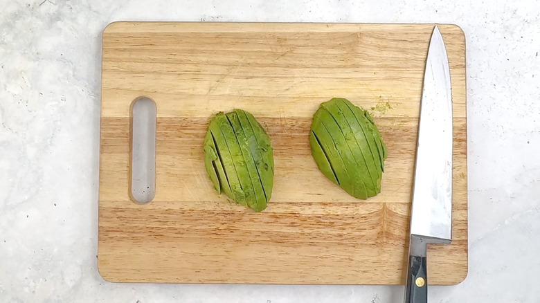 sliced avocado on chopping board