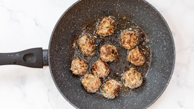 Skillet with browned meatballs