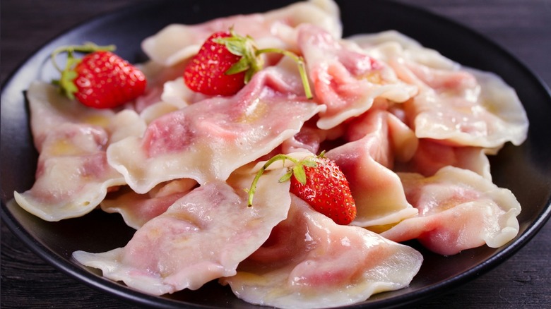 Fruit pierogi topped with strawberries