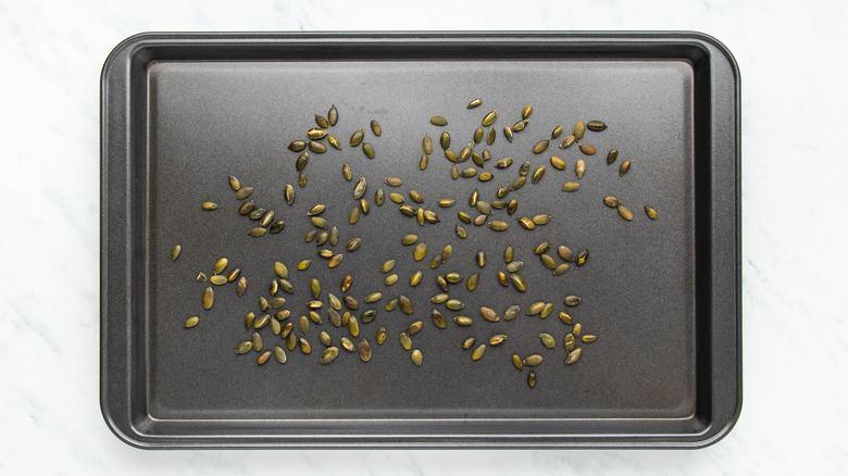 Pumpkin seeds on baking sheet