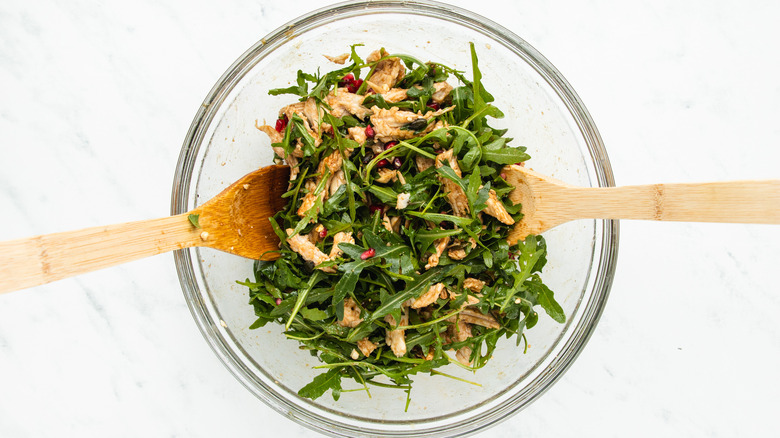 Chicken salad being mixed in bowl