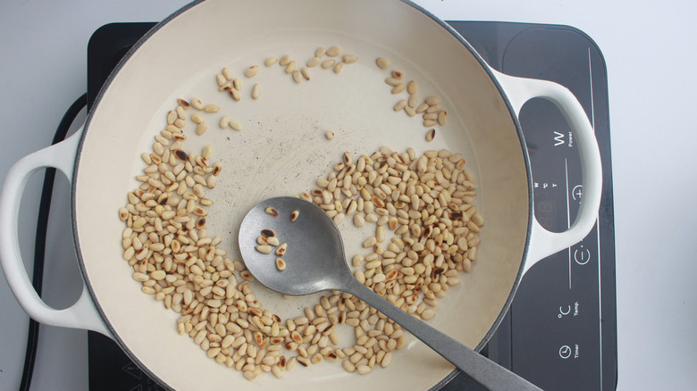 pine nuts toasting in pan