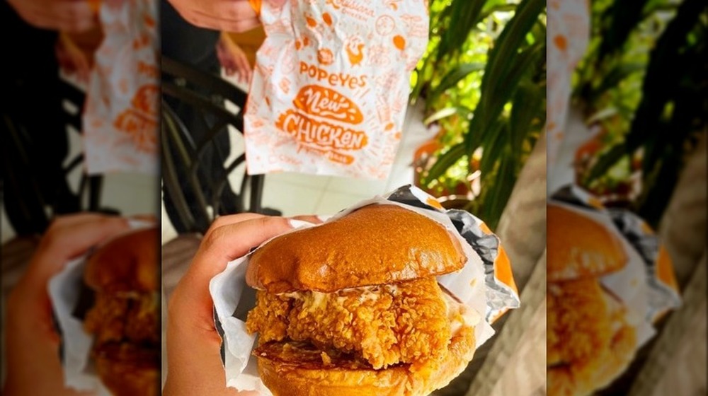 Popeyes chicken sandwich displayed with wrapper