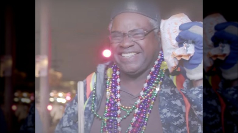 Person with chicken sandwich at Mardi Gras