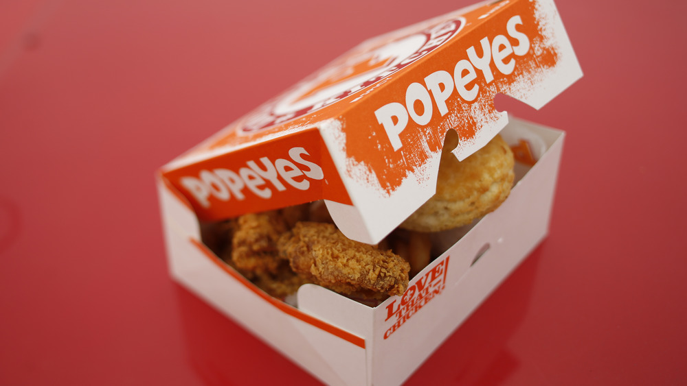 opening box of Popeyes chicken