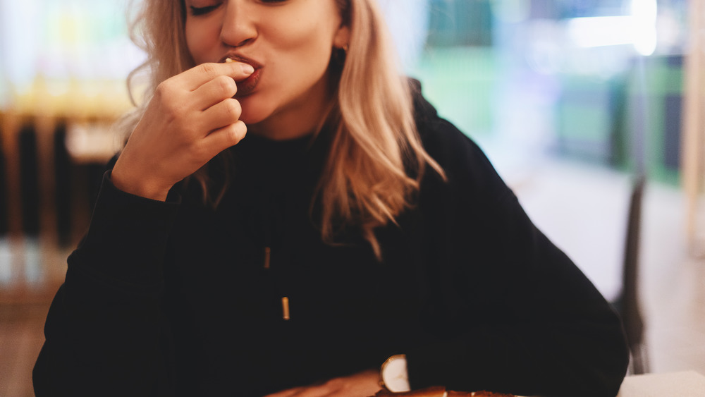 eating in black hoodie