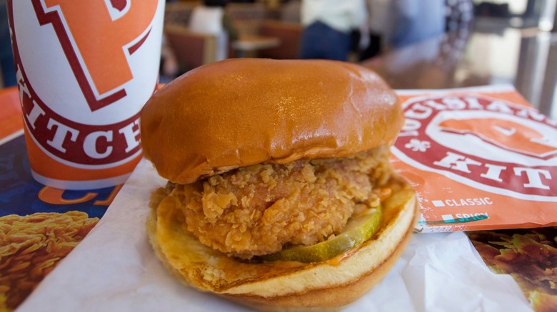 Popeyes chicken sandwich setting on a tray with a drink