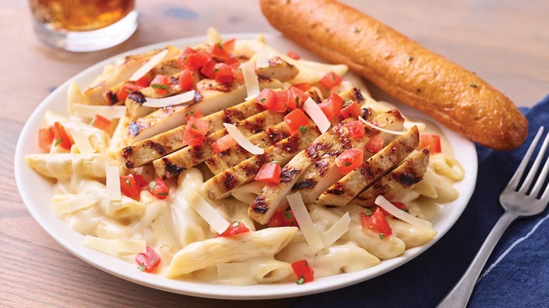 Plate of chicken penne on table