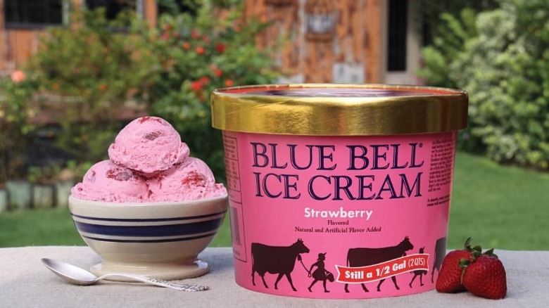 Container and Bowl of Blue Bell Strawberry Ice Cream on a Table