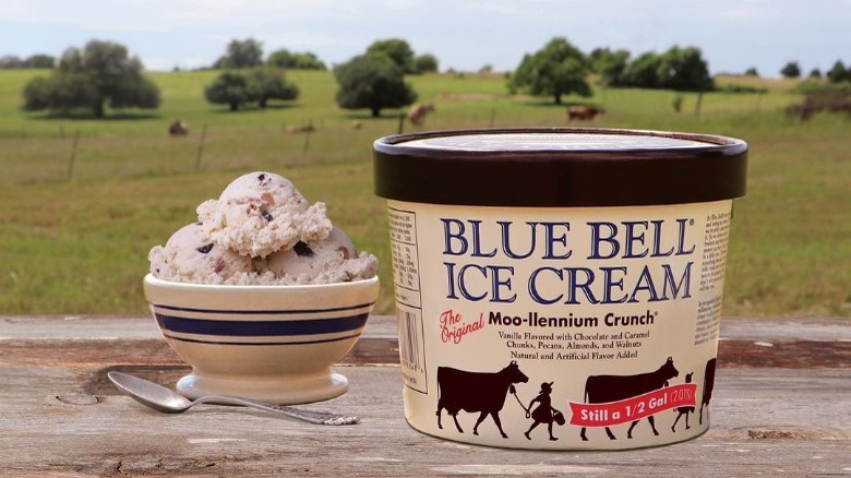 Bowl and Container of Blue Bell Moo-llennium Crunch Ice Cream on a Table Outside