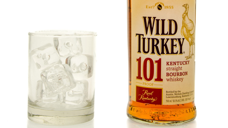 Bottle of Wild Turkey 101 and glass