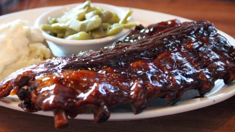 Cheddar's ribs are on a plate with two sides.