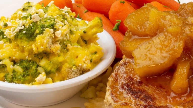 A closeup shows broccoli cheese casserole in a side dish.