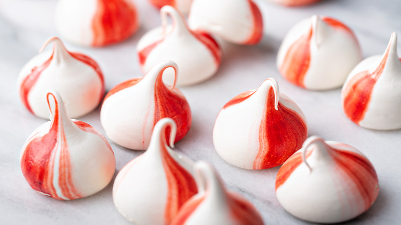Peppermint meringues on white surface