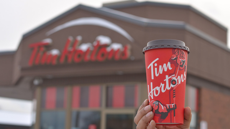 Tim Hortons coffee cup in focus