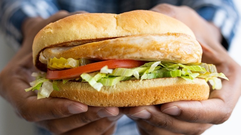  holding Culver's Grilled Chicken Sandwich