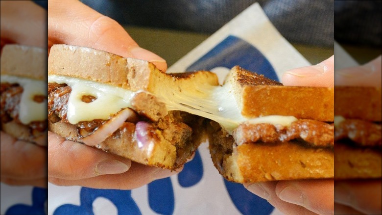 Someone holding Culver's Wisconsin Swiss Melt sandwich