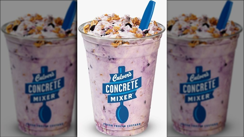 Culver's Blueberry Cobbler Concrete Mixer frozen custard in a cup with a blue plastic spoon