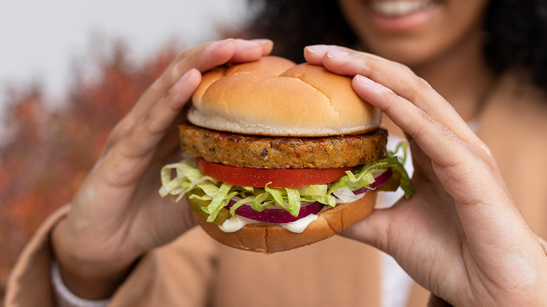 Customer holding Harvest Veggie Burger