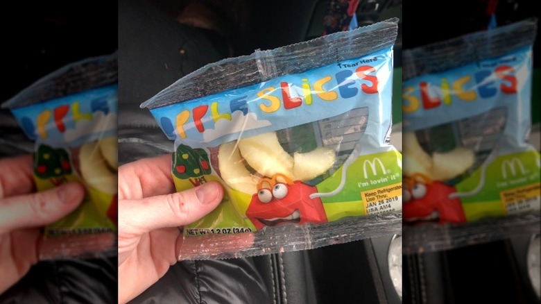 person holding apple slices bag