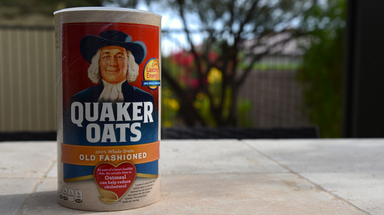 Container of Quaker Oats on table