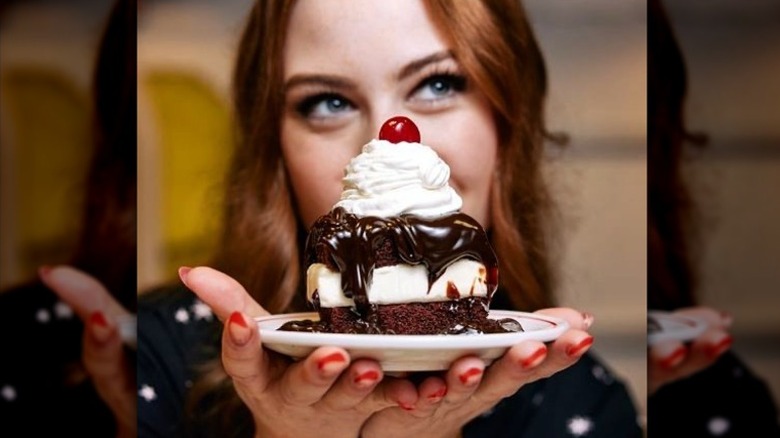 woman holding hot fudge cake