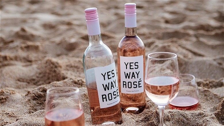 Rose bottles in sand