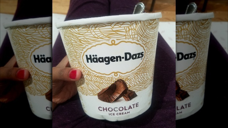 Someone Holding Pint of Haagen-Dazs Chocolate Ice Cream