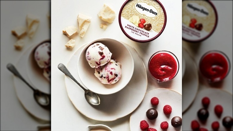 Container and Bowl of Haagen-Dazs White Chocolate Raspberry Truffle Ice Cream with Fresh Berries