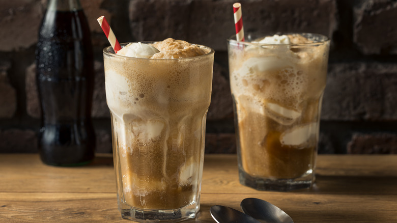 two soda floats with straws