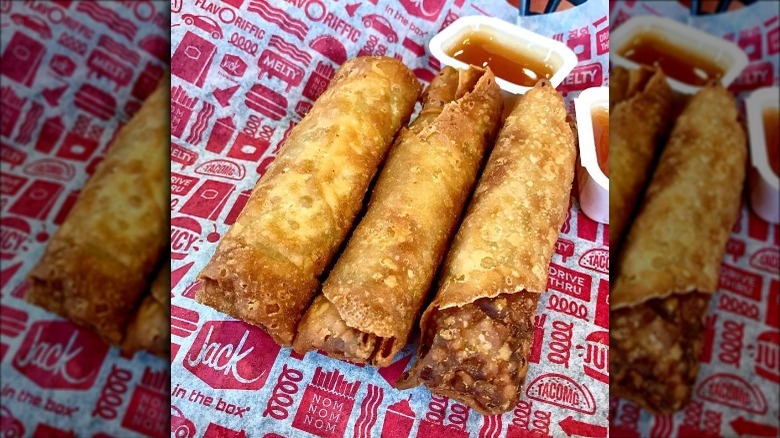 Three Jack in the Box Jumbo Egg Rolls with sauce