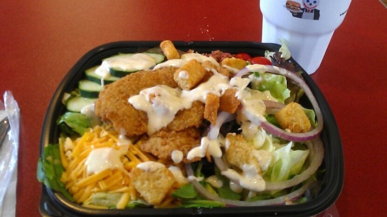 Jack in the Box Chicken Club Salad on table with drink